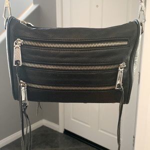 Small black crossbody leather bag.